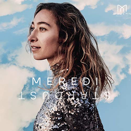 The album cover features a woman in a sparkly top against a cloudy sky.