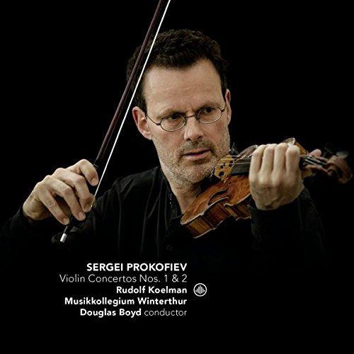 Man holding violin and bow against a black background with white text overlay.
