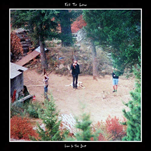 Album cover: three figures in a wooded, dusty clearing.