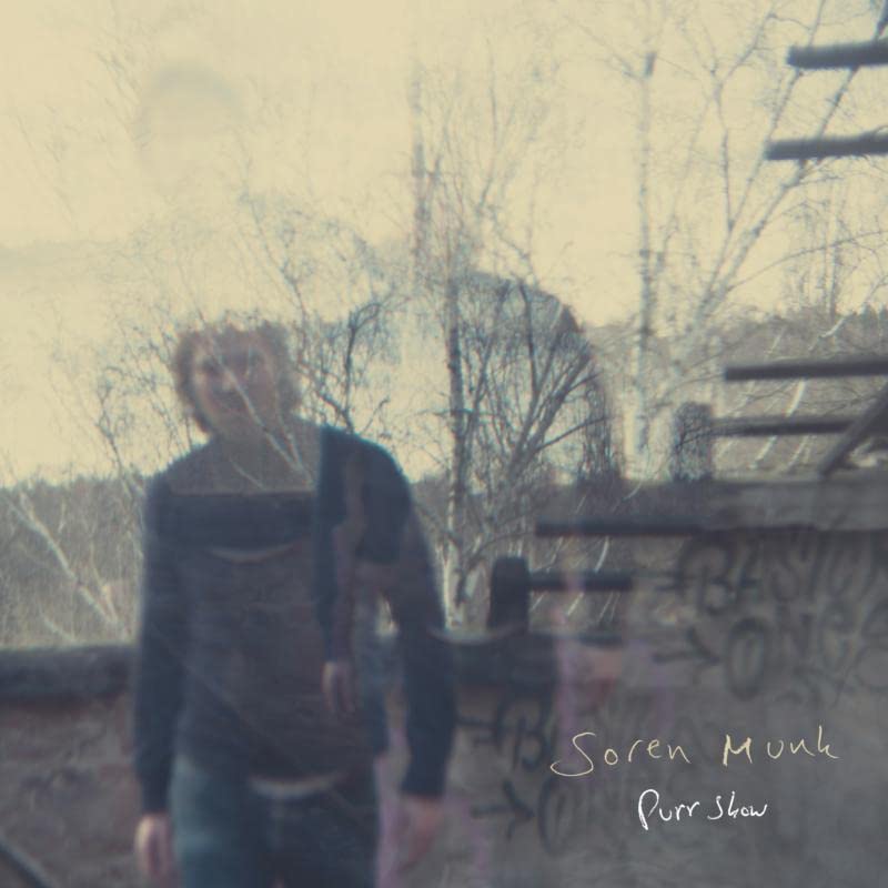 Vinyl record cover: blurry figure with trees and graffiti background.