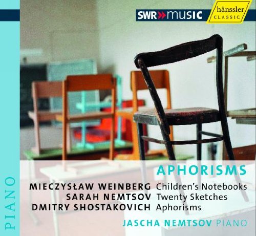 "CD cover with old wooden chairs and piano music composition details."