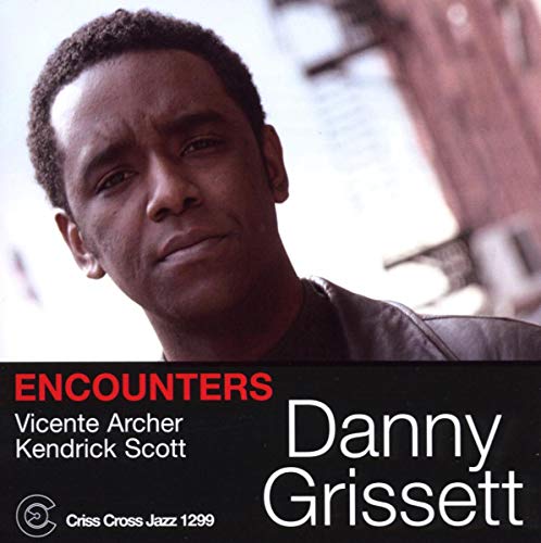 "Danny Grissett's album cover featuring a portrait of him against a blurred cityscape."
