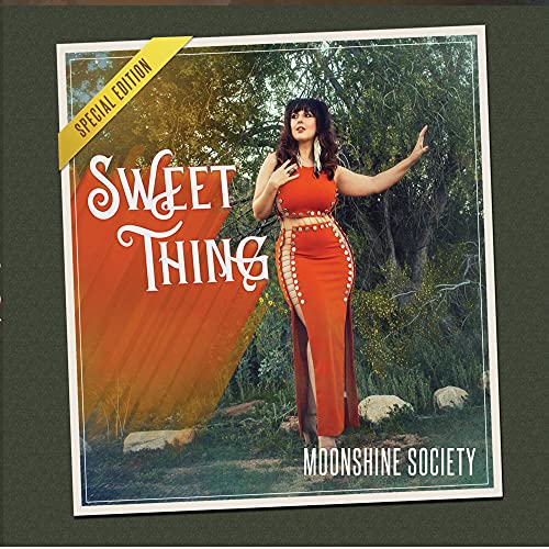 CD cover: woman in red dress standing in a forest.