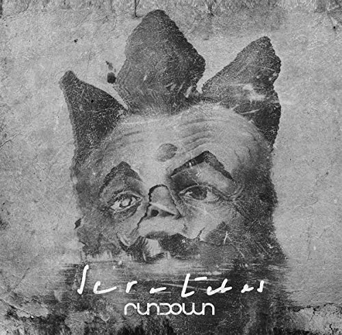 Gritty black and white image of a clown face with pointed ears.