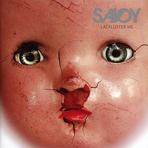 Close-up of a cracked, antique doll face with wide, staring eyes.