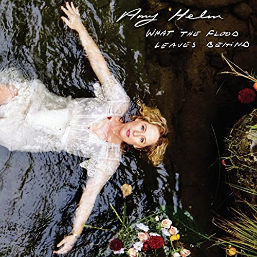 Album cover: woman in water with flowers, titled “What The Flood Leaves Behind.”