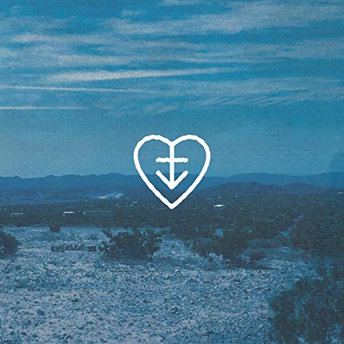The image depicts a blue-toned landscape with a white heart and cross symbol. For accessibility purposes, a concise alt text could be: "Blue landscape with white heart and cross symbol."