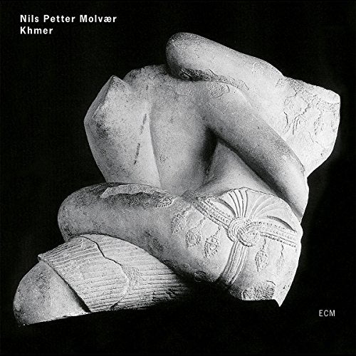 A black-and-white album cover featuring a stone statue against a black background.