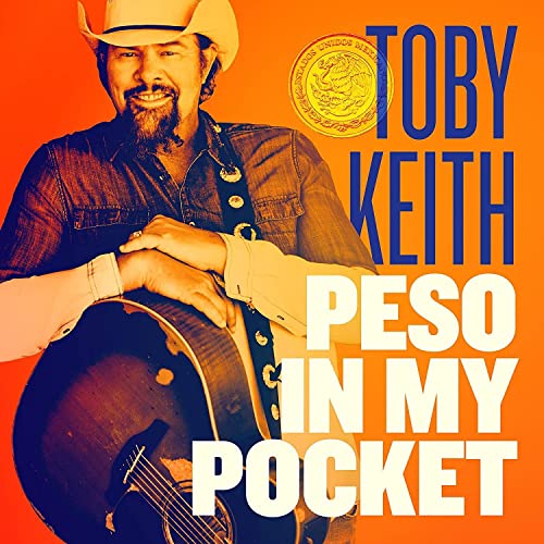 Toby Keith album cover featuring a smiling musician with a guitar.