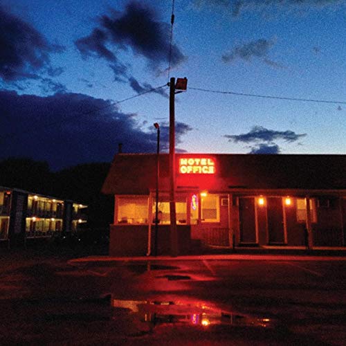 "Album cover featuring a motel office at dusk, lit neon sign, and a puddle."