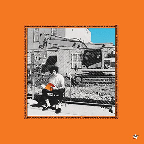 Album cover: man seated near construction site, framed by orange background.