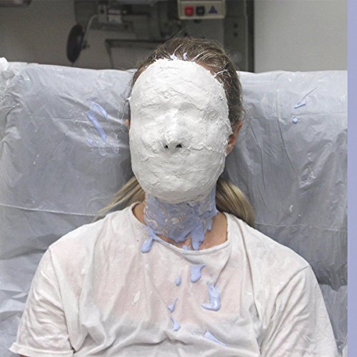 The image depicts a vinyl record with a white face mask design on the cover.