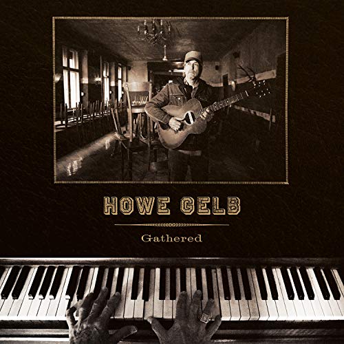 Howe Gelb album cover: musician with guitar in a room with chairs.