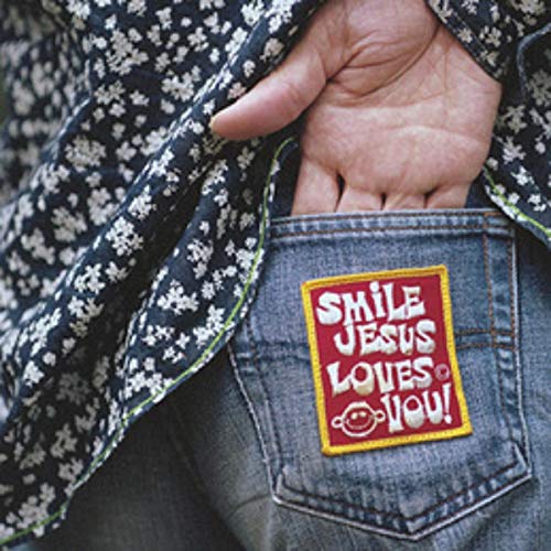Close-up of a denim pocket with a colorful “Smile Jesus Loves You” patch.