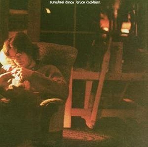 Bruce Cockburn album cover, “Sunwheel Dance,” showing a man seated indoors.