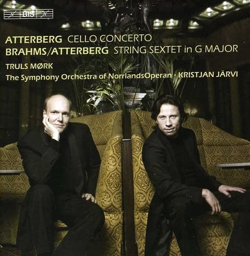 CD cover featuring two men seated on a gold couch, musical scores visible.