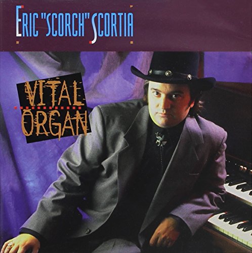 Album cover featuring a man in a hat sitting at a piano.