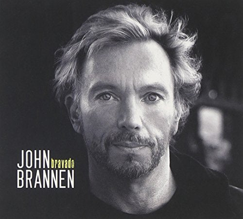 Black-and-white album cover featuring a man with messy hair and a beard.