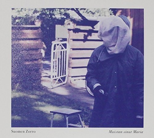 CD cover: hooded figure stands in front of a wooden building.