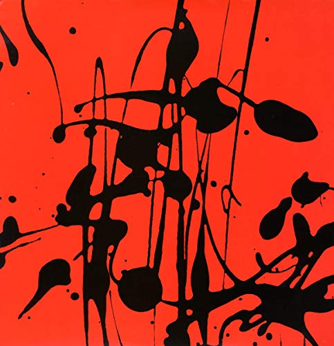 Red vinyl record sleeve with black paint splatters, abstract design.