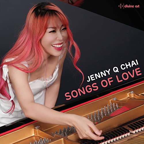 CD cover featuring a smiling woman with pink hair at a piano.