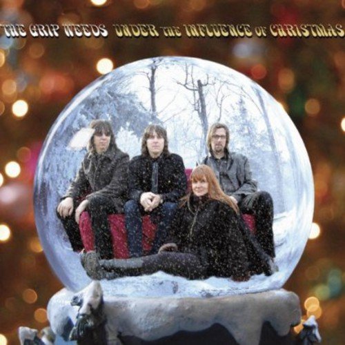 "Album cover featuring four band members inside a snow globe with a festive background."