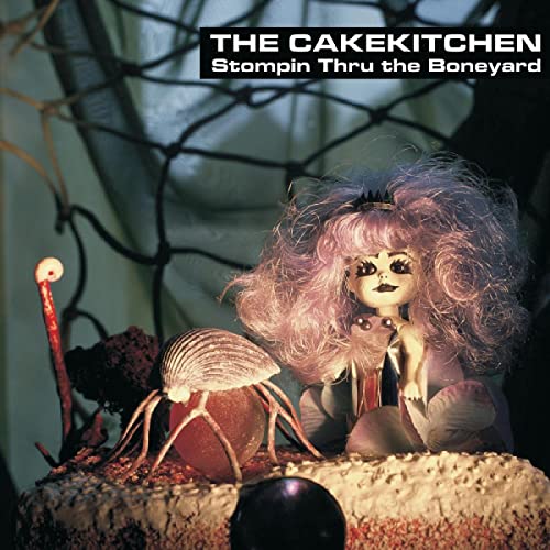 Album cover featuring a doll with a spider on a textured surface.