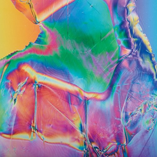 The image shows a vinyl record sleeve with a rainbow-colored, holographic finish. Alt text: Rainbow-colored, holographic vinyl record sleeve with a shiny, reflective surface.