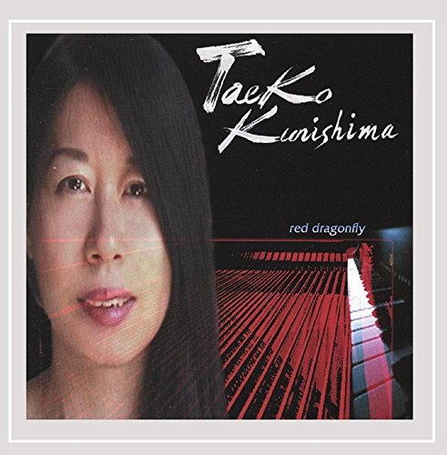 Album cover with a woman's face and a red bridge at night.