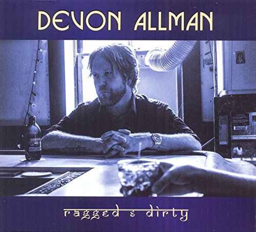 Devon Allman's album cover featuring a man sitting at a table with a bottle.