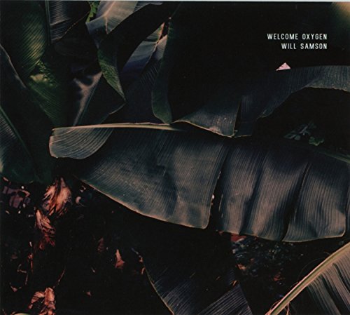 "Album cover featuring dark, wilted banana leaves with text 'Welcome Oxygen Will Samson'."