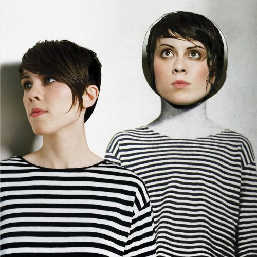 Two women in black and white striped shirts, one with a mannequin head, against a white background.