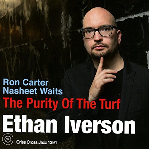 Album cover featuring Ethan Iverson, a bald man in a black suit, contemplative.