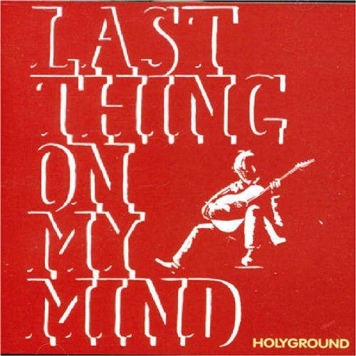 Red album cover with white text and a man playing guitar illustration.