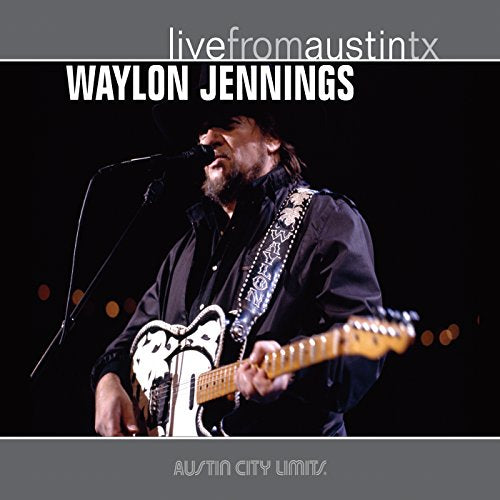 "CD cover of Waylon Jennings performing on stage, playing guitar and singing into a microphone."