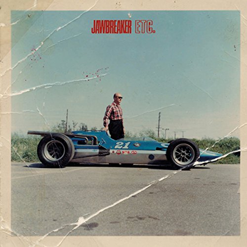 Vinyl album cover: blue race car with a man standing on it.