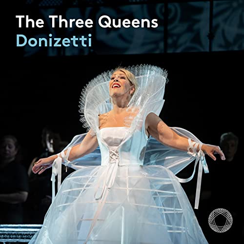 Sondra Radvanovsky in white gown, opera stage background, “The Three Queens” title.