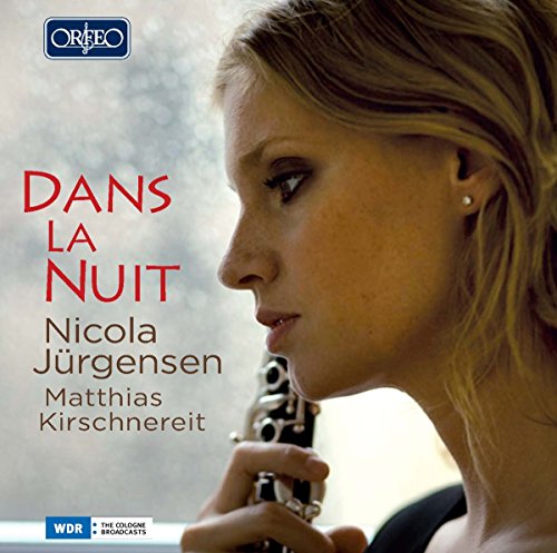 "CD cover featuring a woman playing a clarinet, with text 'Dans La Nuit'."