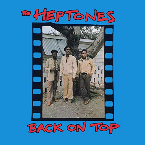 The image shows a blue album cover with four men standing by a tree.
