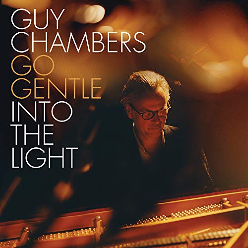 CD cover featuring Guy Chambers at a grand piano, warm tones.