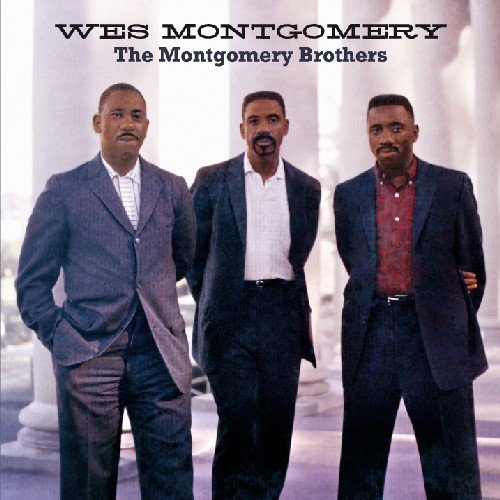 "Album cover featuring three men in suits standing together with white columns behind."