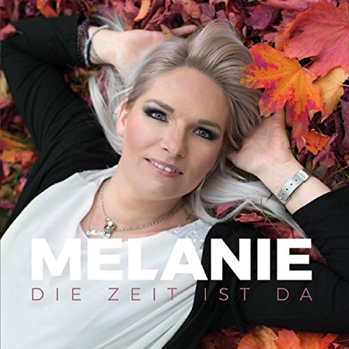 A woman lies on red and orange leaves, smiling, with text overlay.