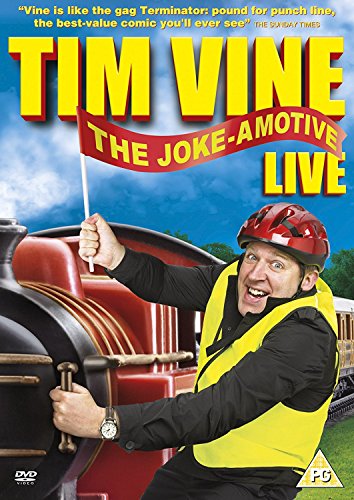 Tim Vine in a yellow vest and helmet, posing with a toy train.