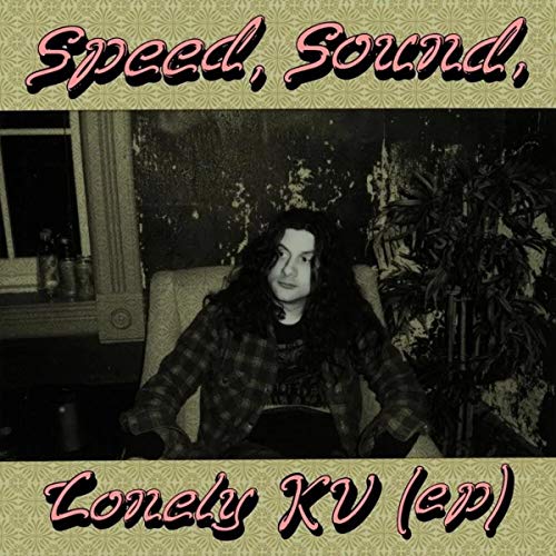 Album cover featuring a person sitting in a room, with text overlay.