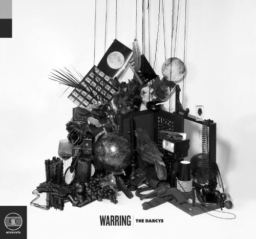 Black and white album cover featuring a chaotic arrangement of objects.