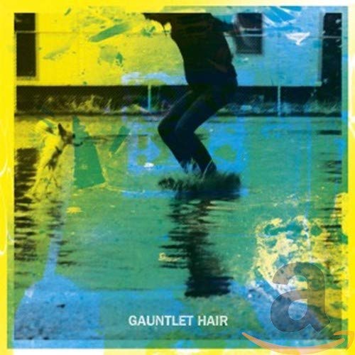 CD cover with a silhouetted figure running through a colorful, wet street.