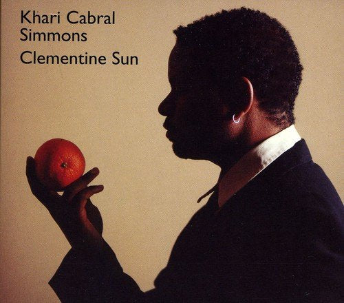 "Album cover: man holding orange, with artist's name and title in black text."