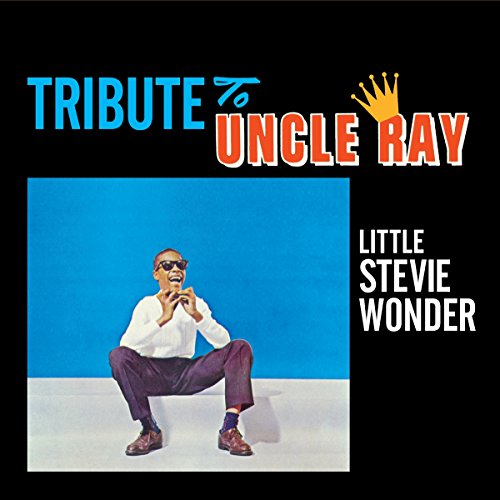 "Album cover featuring a man crouching, holding a harmonica, against a blue background."