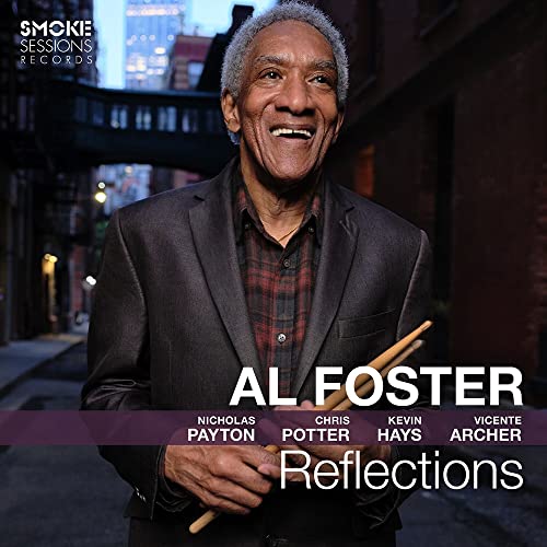 Al Foster album cover: smiling man with drumsticks in a city street.
