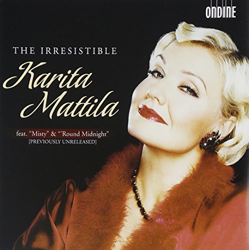 "CD cover featuring a blonde woman in a red fur-trimmed coat against a black background."